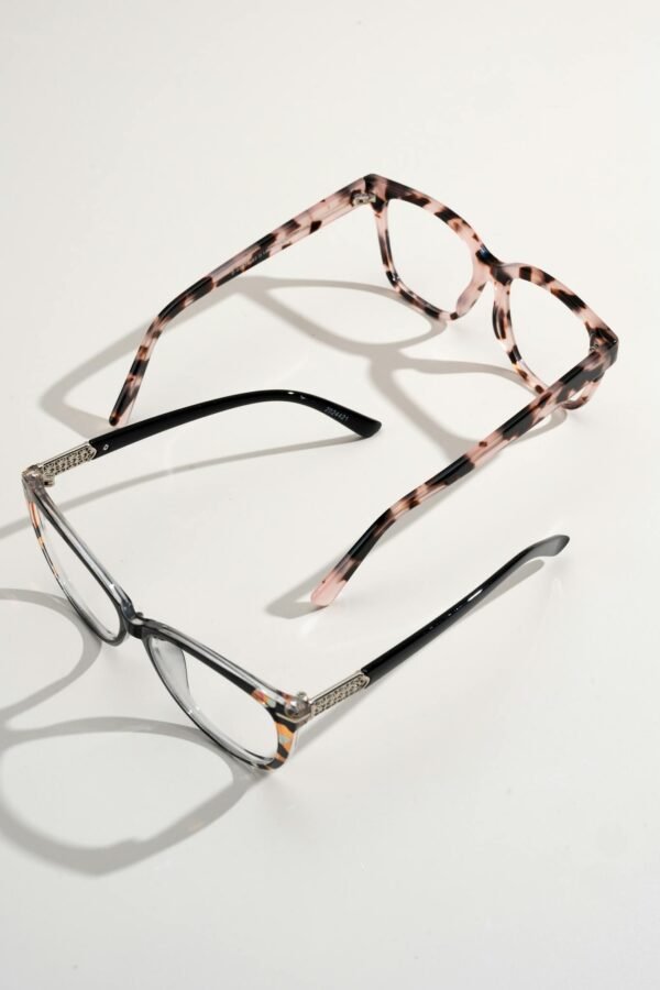 A pair of stylish eyeglasses and sunglasses displayed on a white background.