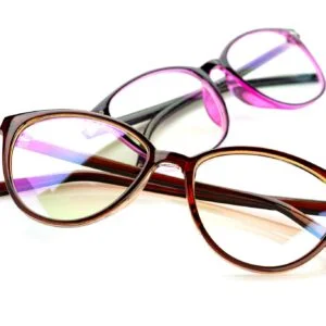 Close-up shot of fashionable brown and purple eyeglasses on a white background.